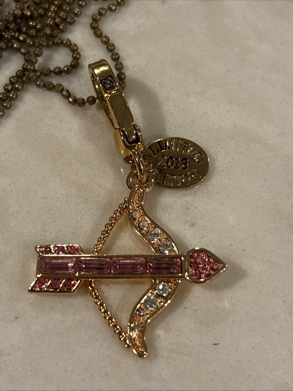 Juicy Couture limited edition Gold Bow & Arrow Pendant Necklace with Pink Stones